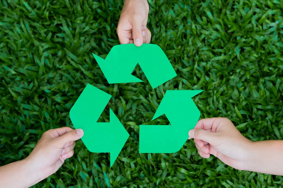Hands holding a recycling symbol